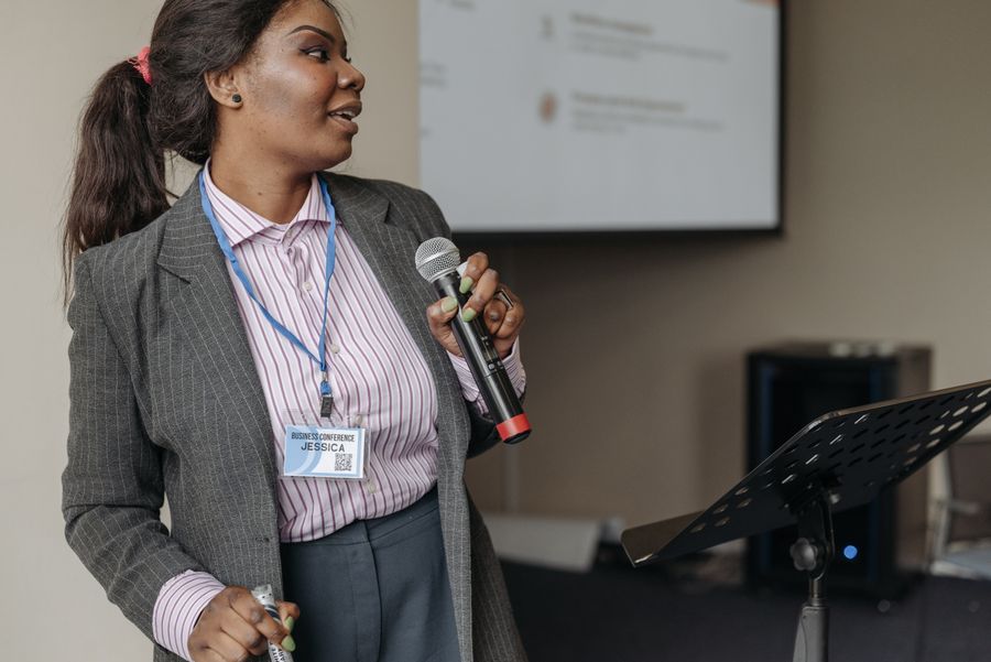 A speaker holding a microphone
